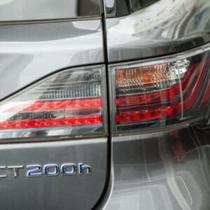 Closeup of rear light and sign on grey Lexus CT 200h parked in the street