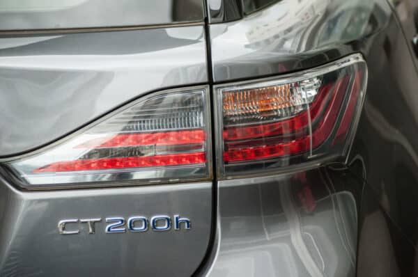 Closeup of rear light and sign on grey Lexus CT 200h parked in the street